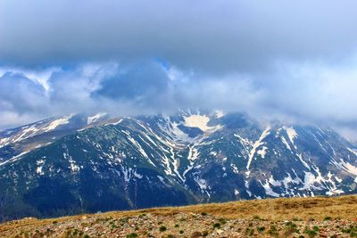 Scenic view of snowcapped mountains against sky