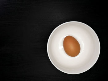 High angle view of tea cup against black background