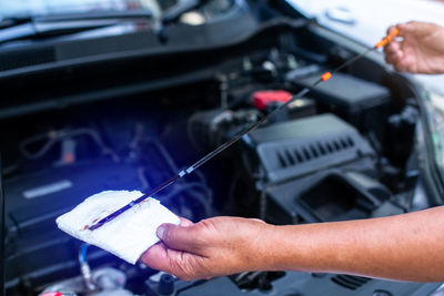 Cropped hand of man repairing car