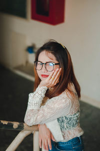 Portrait of smiling woman standing at home