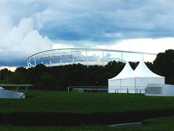 View of greenhouse against cloudy sky