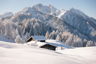 Wooden mountain authentic hut in the alps in winter. winter snowy background