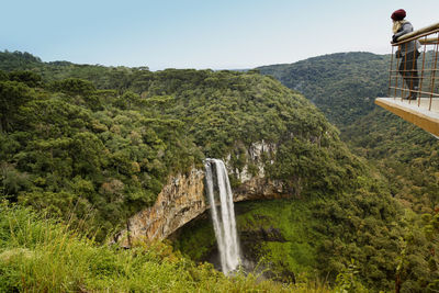 Scenic view of waterfall against sky