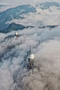 High angle view of communications tower and building against sky