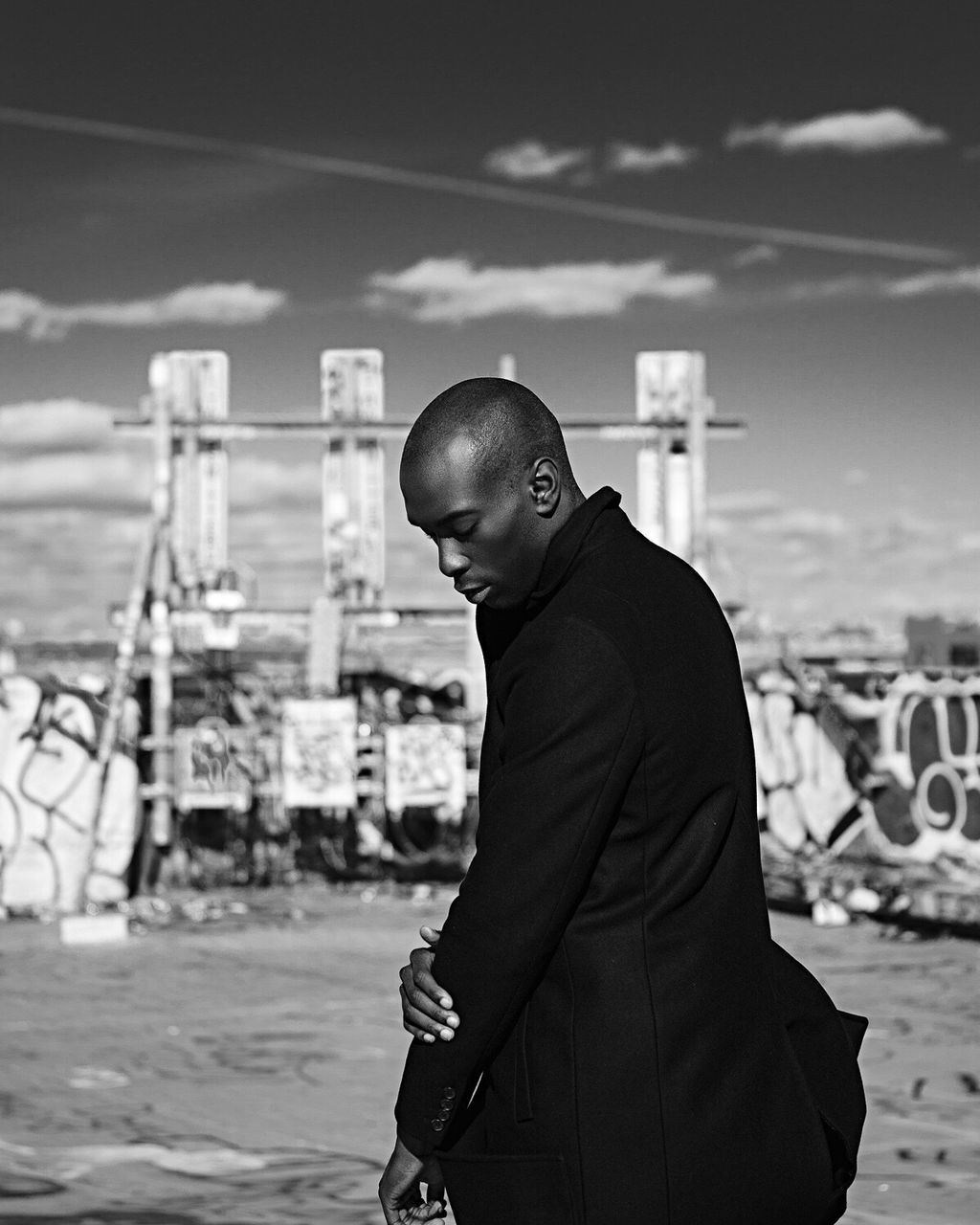 shaved head, one man only, only men, hair loss, one person, adults only, waist up, mid adult men, side view, men, black color, archival, cultures, people, outdoors, adult, looking down, well-dressed, businessman, day, young adult