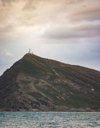 Scenic view of sea and mountains against sky
