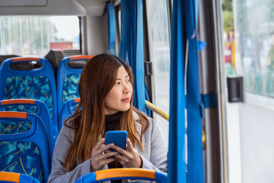 Young woman looking through mobile phone