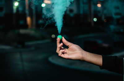 Cropped hand of man holding sparkler