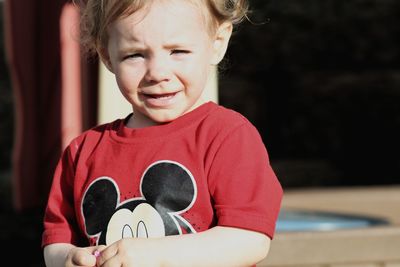 Portrait of smiling boy holding camera