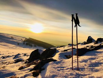Scenic view of snow covered landscape against sky during sunset