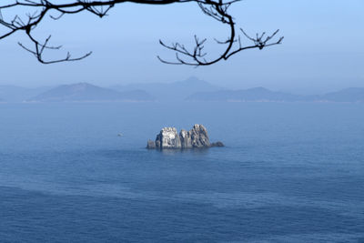 Scenic view of sea and mountains against sky