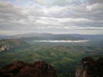 Scenic view of mountains against cloudy sky