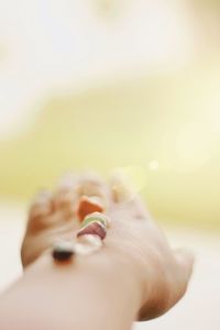 Close-up of woman hand over blurred background