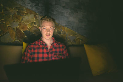 Portrait of young man sitting at home