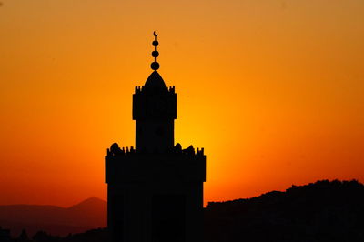 Silhouette building against sky during sunset 
mosque against sky during sunset 