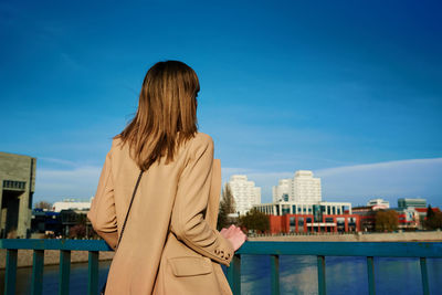 Cheerful woman walks at europe city street