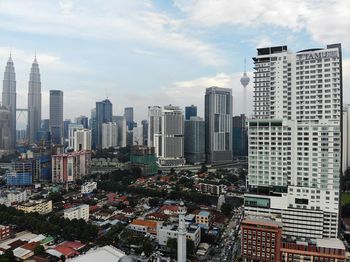 Aerial view of modern buildings in city against sky