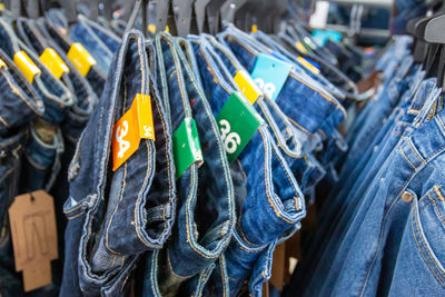 Close-up of jeans hanging for sale at store