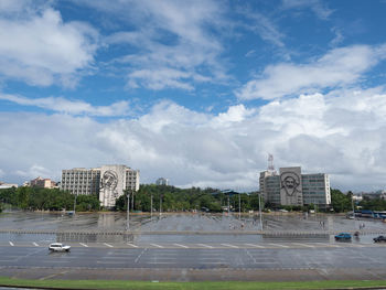 Buildings in city against cloudy sky