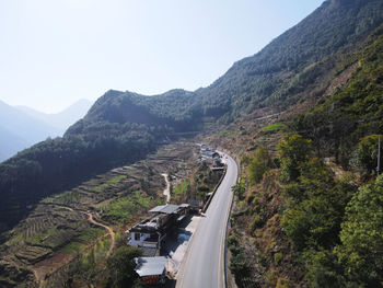 High angle view of road amidst mountains against clear sky