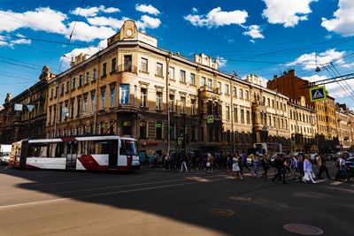 Vehicles on road along buildings