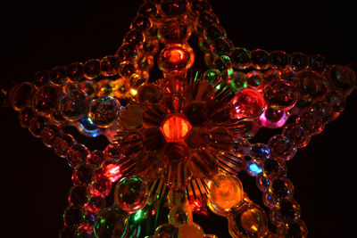 Low angle view of illuminated christmas tree against sky at night