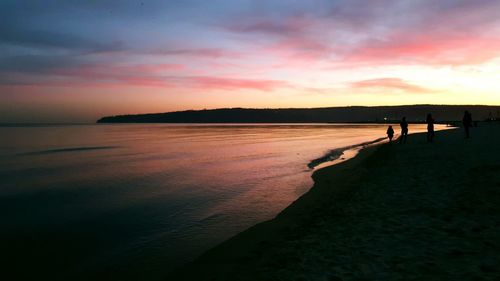 Scenic view of beach against sky during sunset
