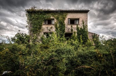 Low angle view of building against cloudy sky