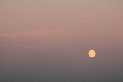 Low angle view of moon against sky at sunset