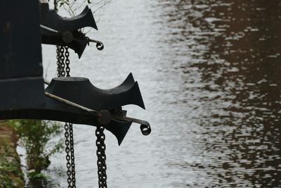 Close-up of chain hanging on boat in lake