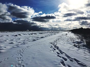 Scenic view of frozen lake against sky