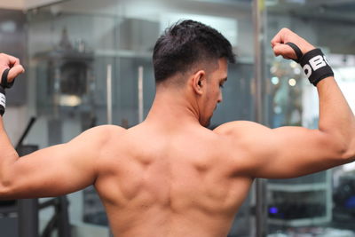 Close-up of shirtless man looking at camera