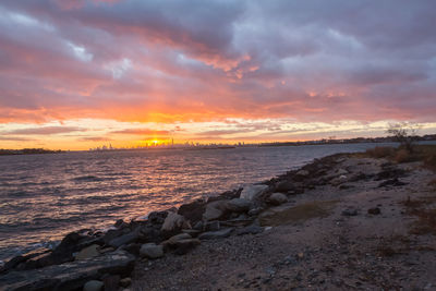 View of sea against cloudy sky during sunset