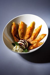 Close-up of food in bowl against black background