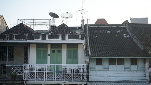 Buildings in city against clear sky