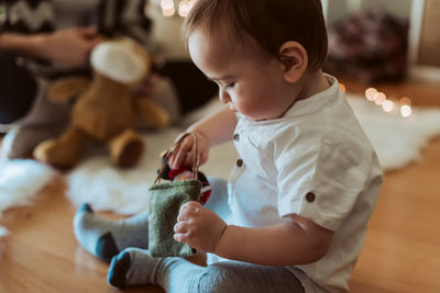 Cute boy playing with baby