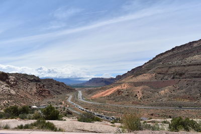 Panoramic view of road leading towards mountains against sky