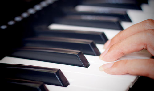 Close-up of hands playing piano