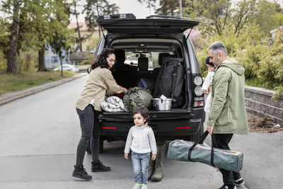 Parents with children near car