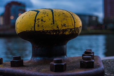 Close-up of yellow bollard