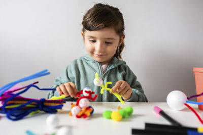 Portrait of a boy playing with toy