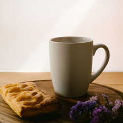 Close-up of coffee and puff pastry on table