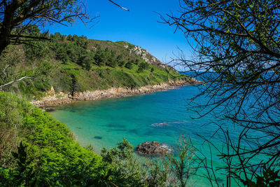 Scenic view of sea against clear blue sky