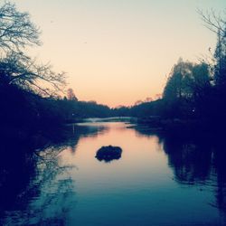 Scenic view of calm lake at sunset