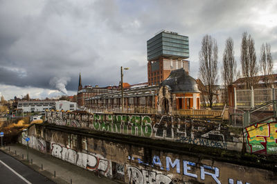 Buildings against cloudy sky