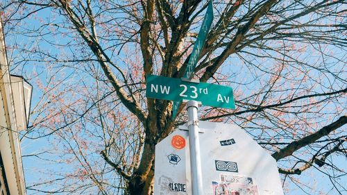 Low angle view of road sign against sky