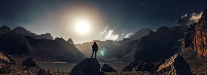 Scenic view of mountains against sky at night