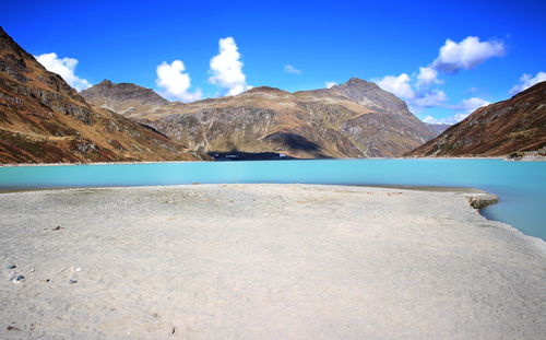 Scenic view of mountains against blue sky