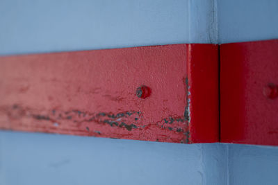 Close-up of red door on wall