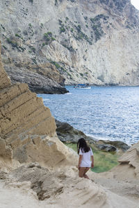 Woman on rock at beach